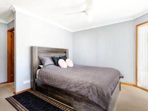 a bedroom with a bed with two pillows on it at Close To The Myall River Pet Welcome in Hawks Nest