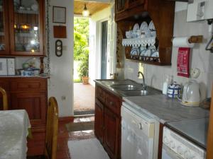 a kitchen with a sink and a counter top at Casa do Areal in São Roque do Pico