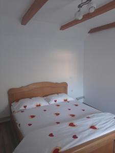 a bedroom with a bed with hearts on the sheets at Cabana plaiului in Vişeu de Sus