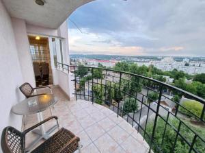 a balcony with a table and chairs and a view at M.Dosoftei 126 in Chişinău