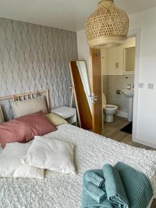 a bedroom with a bed and a bathroom at Family Friendly Maritime Apartment in Swansea