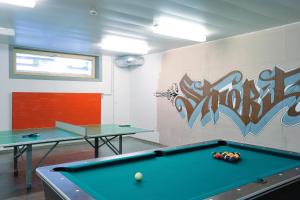 a billiard room with two ping pong tables at St. Moritz Youth Hostel in St. Moritz