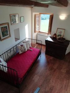 a bedroom with a bed with a red blanket at Casetta dei sibillini in Fiastra