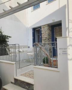 Cette maison blanche dispose d'une porte et d'un balcon. dans l'établissement Petra stonehouse near the Port, à Panormos Skopelos