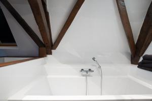 a bathroom with a shower and a glass tub at Logement de Spaerpot in Middelburg