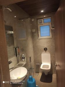 a bathroom with a toilet and a sink at Hotel Dream Residency in Navi Mumbai