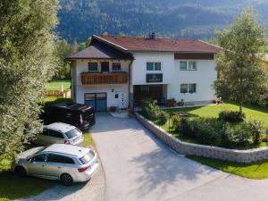 an aerial view of a house with two cars parked at MAXAlpin Appartements in Längenfeld