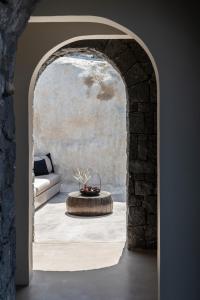 an archway with a coffee table in a living room at Nimbus Santorini in Oia