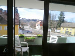 a view of a balcony with two chairs and a window at Ferienwohnung am Cambomare in Kempten