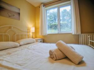 a bedroom with a large white bed with a window at Rossnowlagh Creek Chalet 5 in Rossnowlagh