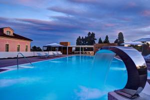 a large swimming pool with a water slide at Castello Dal Pozzo Resort Lago Maggiore - Preferred Hotels & Resorts in Oleggio Castello +145 photos