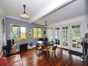 a living room with a table and chairs at Where the River Runs in Tea Gardens