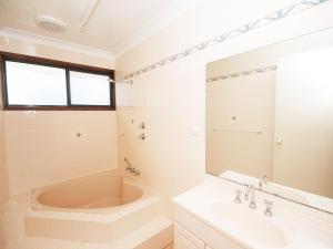 a bathroom with a tub and a sink at Pet Friendly on Pelican Close to Myall River in Hawks Nest