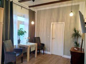 a dining room with a table and chairs and a window at Haus Heideblick in Undeloh