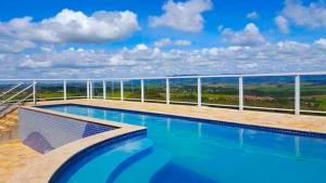 a swimming pool with a view of the ocean at Hotel Serra do Itaqueri in Charqueada
