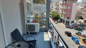 a balcony with chairs and an air conditioner on a building at Kapsouli Square Komotini in Komotini