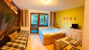 a bedroom with a bed and a couch in it at Apartment studio No.314 in Fatrapark1 in Ružomberok