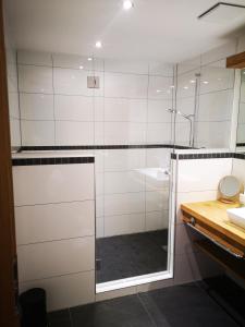 a shower with a glass door in a bathroom at Appartement Seejoch in Seefeld in Tirol