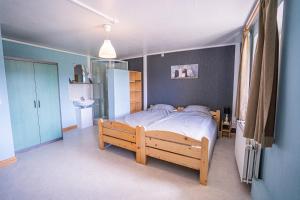 a bedroom with a large bed with a wooden frame at Haus Zur Schmiede in Recht