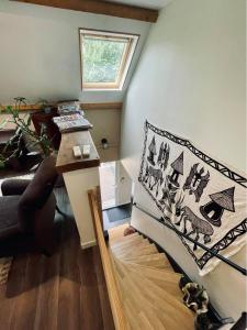 a living room with a bed and a window at Le Boulay in Guichen