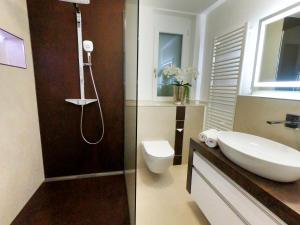 a bathroom with a toilet and a sink and a shower at Antike & Modern DELUXE in Günzburg +16 photos