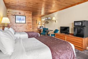 a hotel room with two beds and a flat screen tv at Early Blue Motel in Saluda