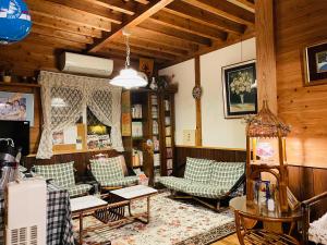 a living room with couches and chairs in a house at Sanrinsha in Takamori