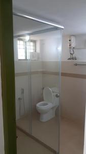 a bathroom with a toilet in a glass enclosure at Aanandakosha Ayurveda Retreat in Trivandrum