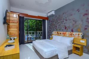 Un ou plusieurs lits dans un hébergement de l'établissement Paradise Retreat, Maafushi