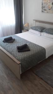 a bedroom with two beds with black towels on them at Apartman Alma in Bihać