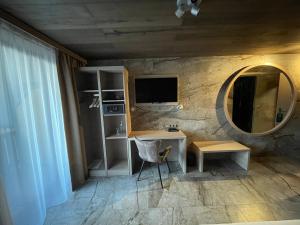 a room with a desk and a mirror and a chair at Hotel Fohlenhof in Ampfing