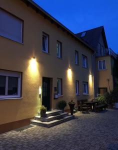 a large building with a patio in front of it at Mainsommer in Kemmern