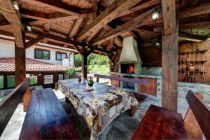 an outdoor patio with a table and a fireplace at House Maya in Tryavna