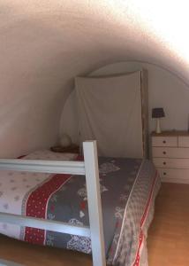 a bedroom with a bunk bed with a canopy at les magnolias in Colmar