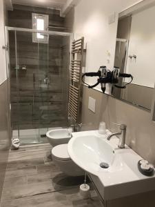 a bathroom with a sink and a toilet and a shower at B&B I BRONZI in Reggio di Calabria