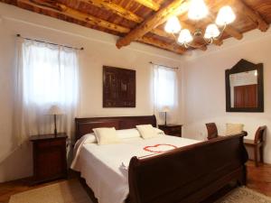 a bedroom with a large bed with a wooden ceiling at Can Mariano in Ibiza Town