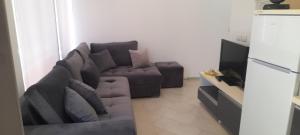 a living room with a couch and a refrigerator at eri apartament in Himare