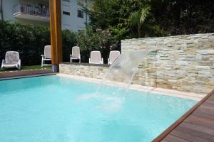 The swimming pool at or close to Residence Rivachiara (check-in at Hotel Riviera in Viale Rovereto, 95)