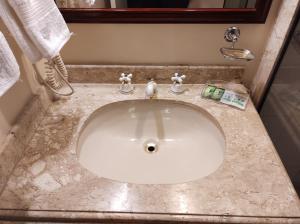 a bathroom sink with a marble counter top at The Time Flat - Berrini - 200 metros do WTC in Sao Paulo +39 photos