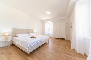 Posteľ alebo postele v izbe v ubytovaní Central Seaside Residence