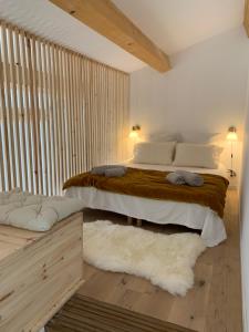 a bedroom with a large bed with white sheets and pillows at La Bergerie du Roy-Chambres D'hôtes- in Rognes