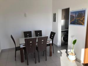 a dining room with a table and chairs at Fumba Apartment in Dambani