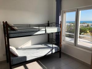 two bunk beds in a room with a window at Fumba Apartment in Dambani