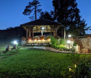 a home with a gazebo at night at Vila Zorica Vodice in Zlatibor