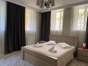 a bedroom with a bed with two towels on it at nikani in Borjomi