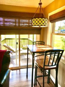 a dining room with a table and chairs and a chandelier at Beech Mountain Cozy Condo in Beech Mountain