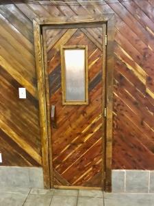 a door in a wooden wall with a mirror at Beech Mountain Cozy Condo in Beech Mountain +9 photos