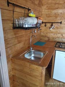 a kitchen with a sink in a wooden wall at Camping Borghetti in Ortona