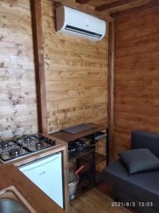 a kitchen with a stove in a wooden wall at Camping Borghetti in Ortona