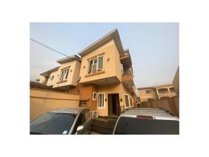 a house with two cars parked in front of it at Amazing 4 Bedroom Duplex in Ikeja Allen Avenue in Ikeja